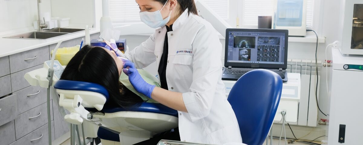 A dentist cleans a patient's teeth. She can receive tax savings when she uses a trusted Miami CPA.