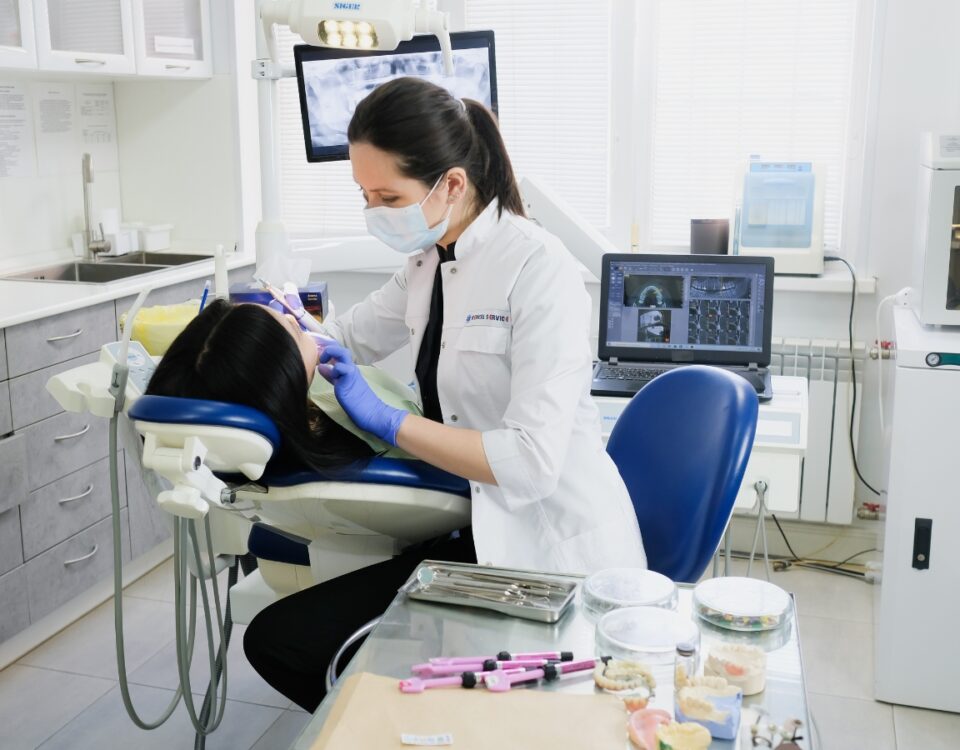 A dentist cleans a patient's teeth. She can receive tax savings when she uses a trusted Miami CPA.